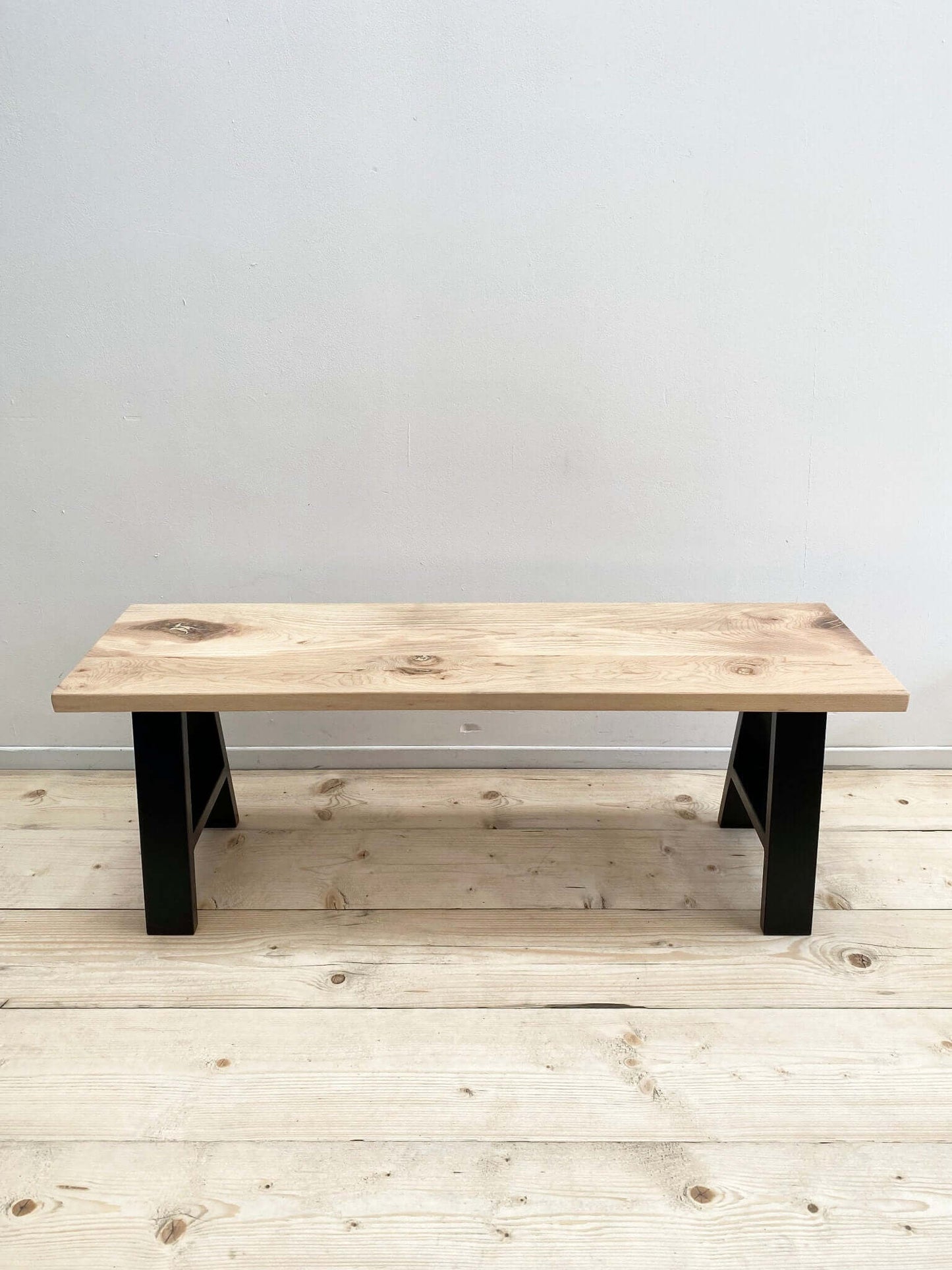 Hardwood bench seat with industrial legs.