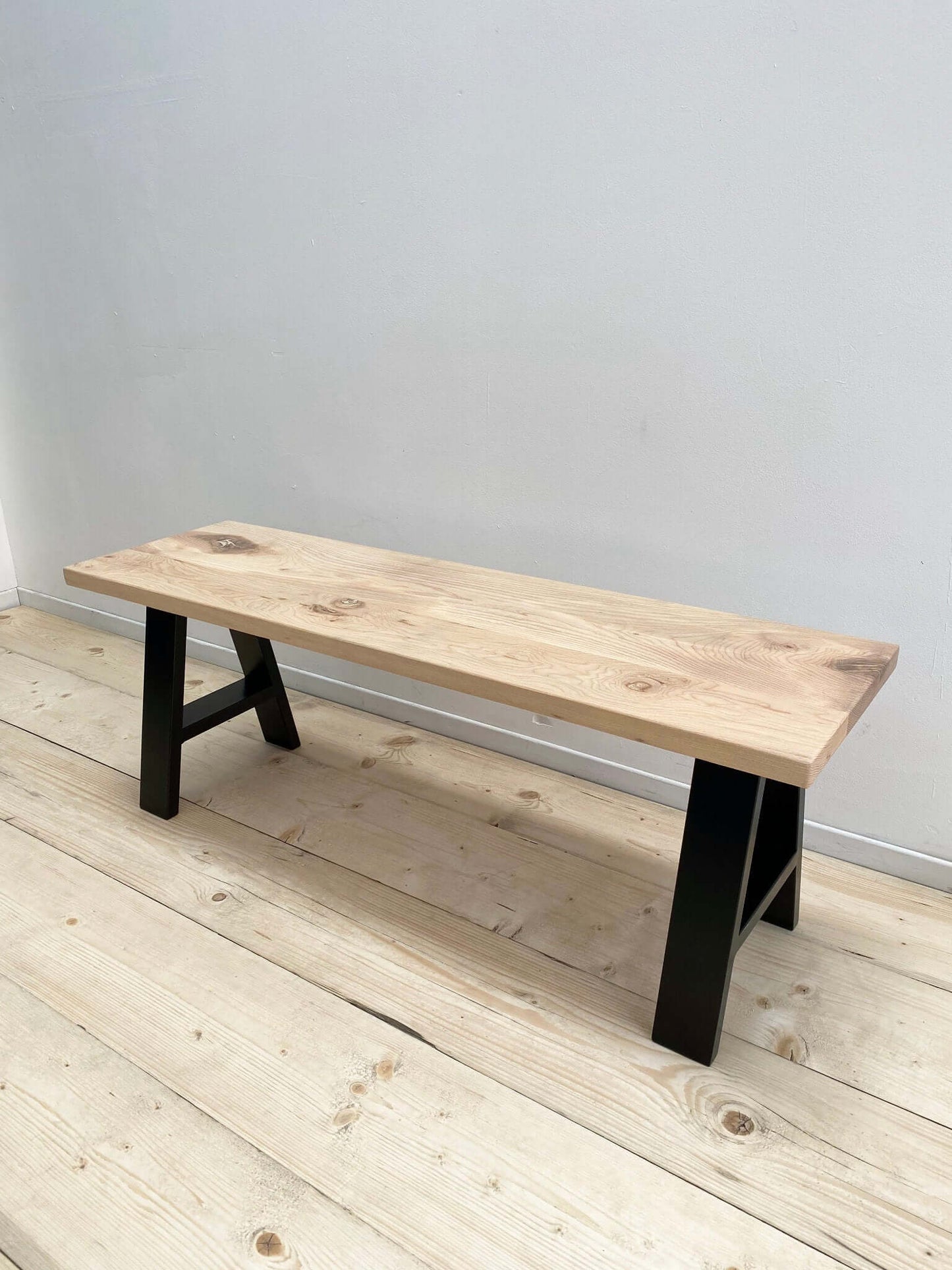 Hardwood bench seat with industrial legs.