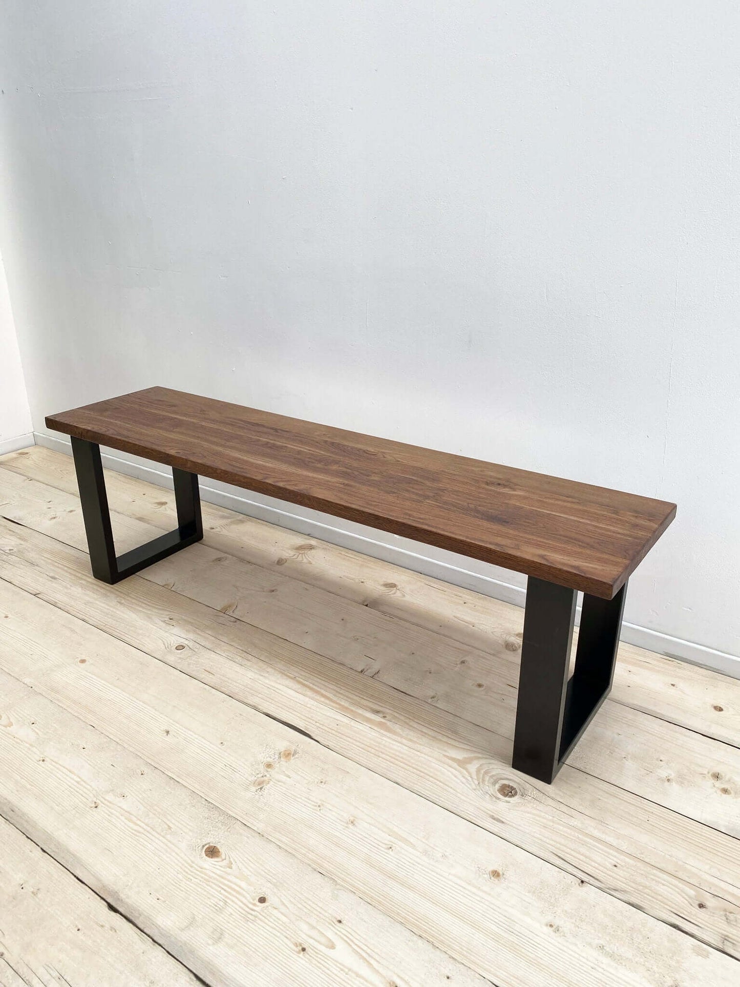 Hardwood bench seat with industrial legs.