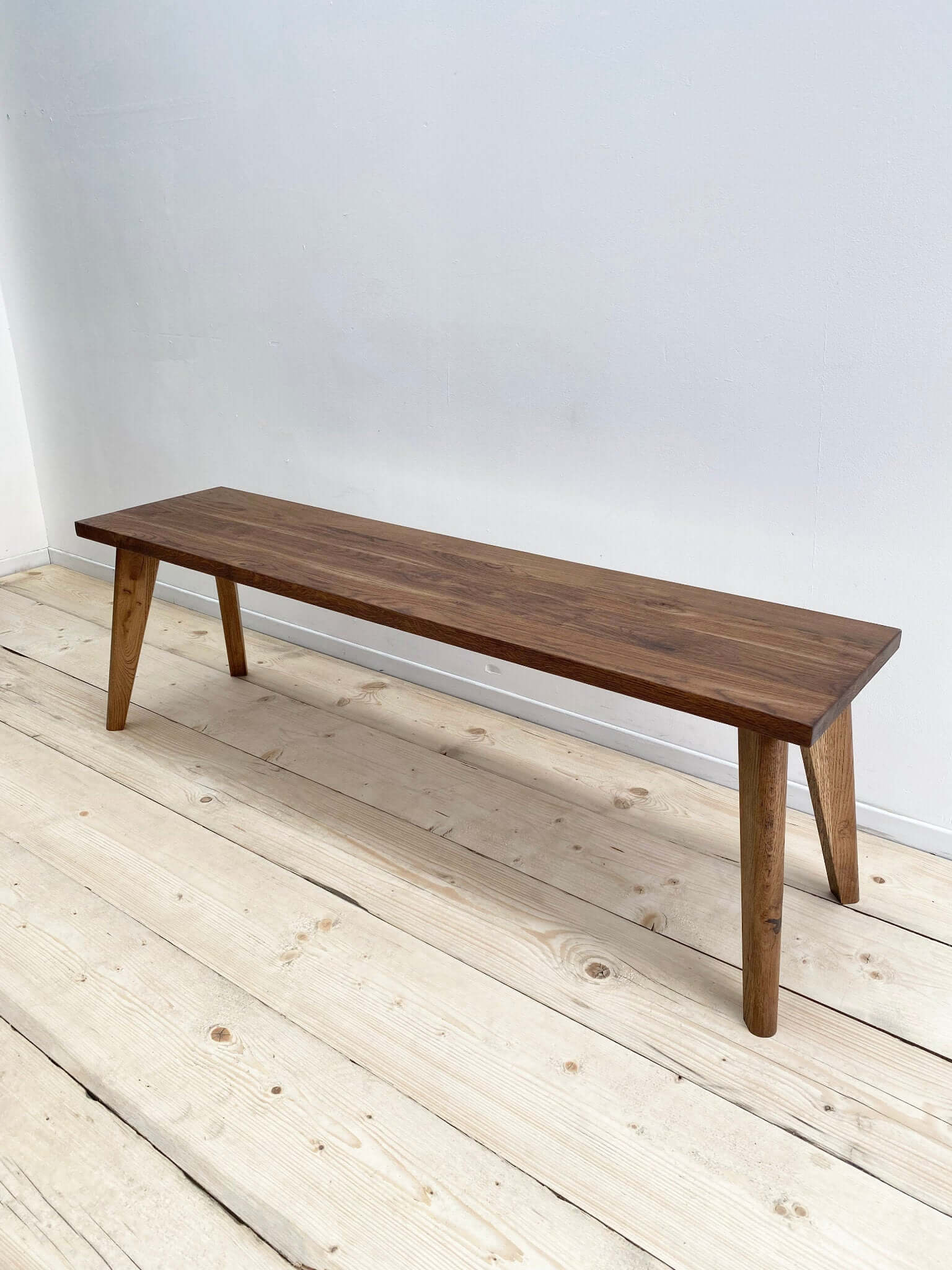 Hardwood bench seat with solid wood legs.