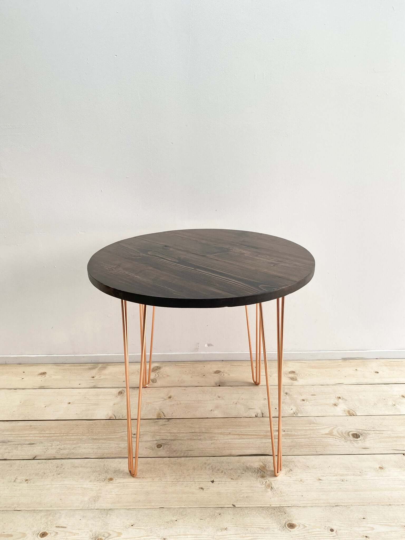 Reclaimed wood circle dining table with hairpin legs.