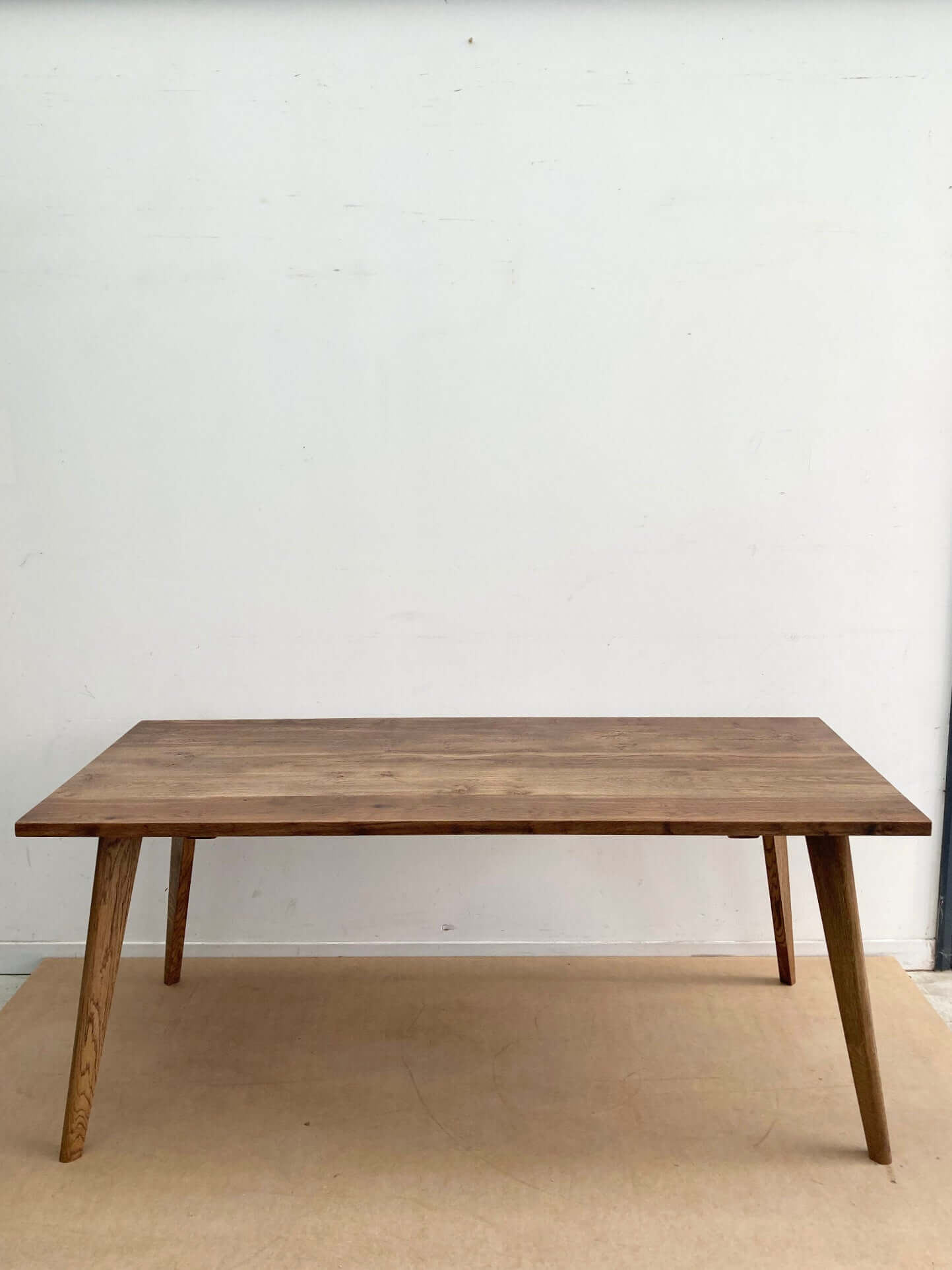 Hardwood large dining table with solid wood legs.