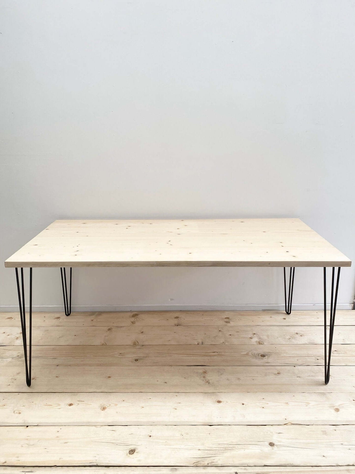 Reclaimed wood large dining table with hairpin legs.