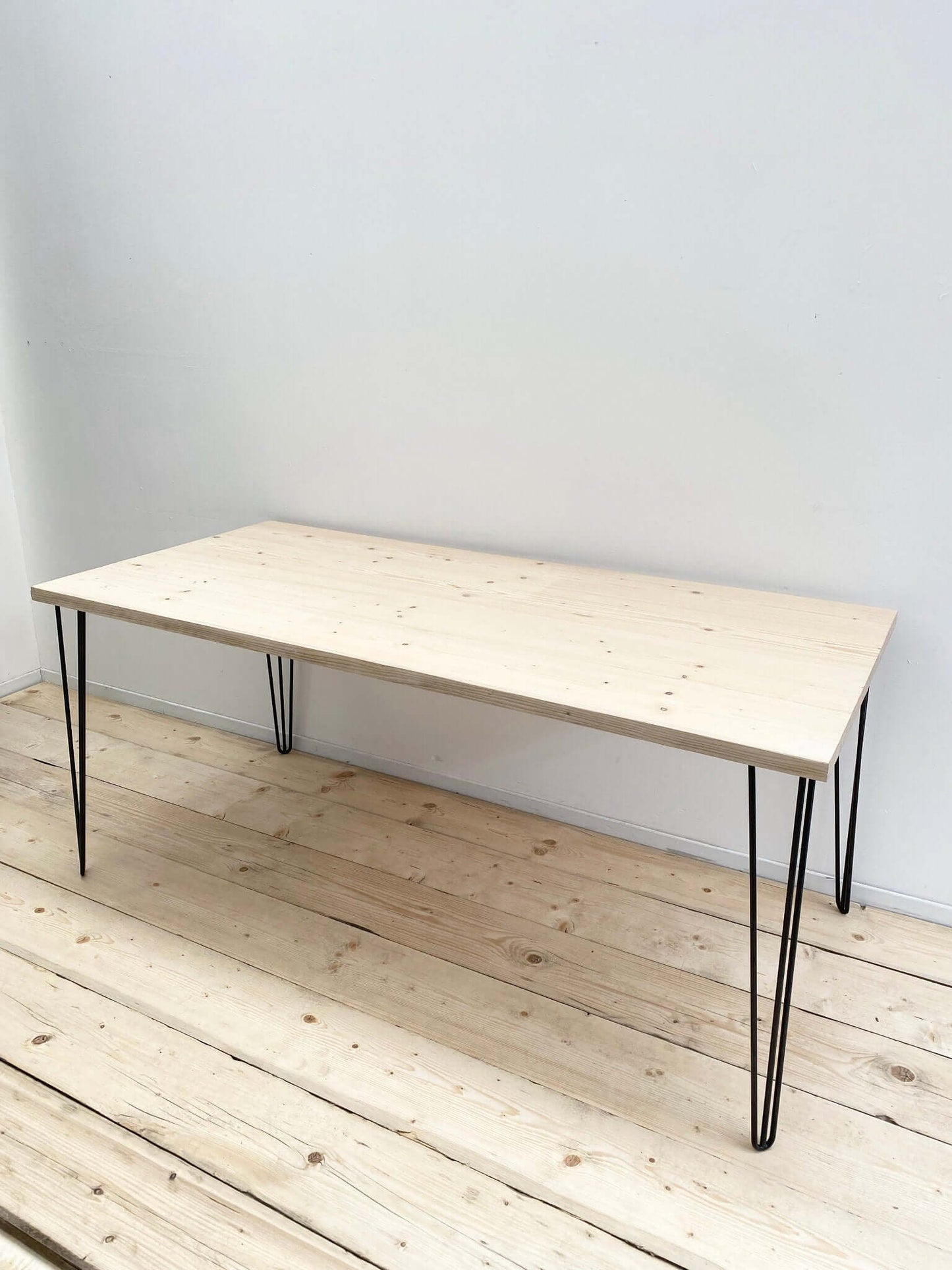 Reclaimed wood large dining table with hairpin legs.