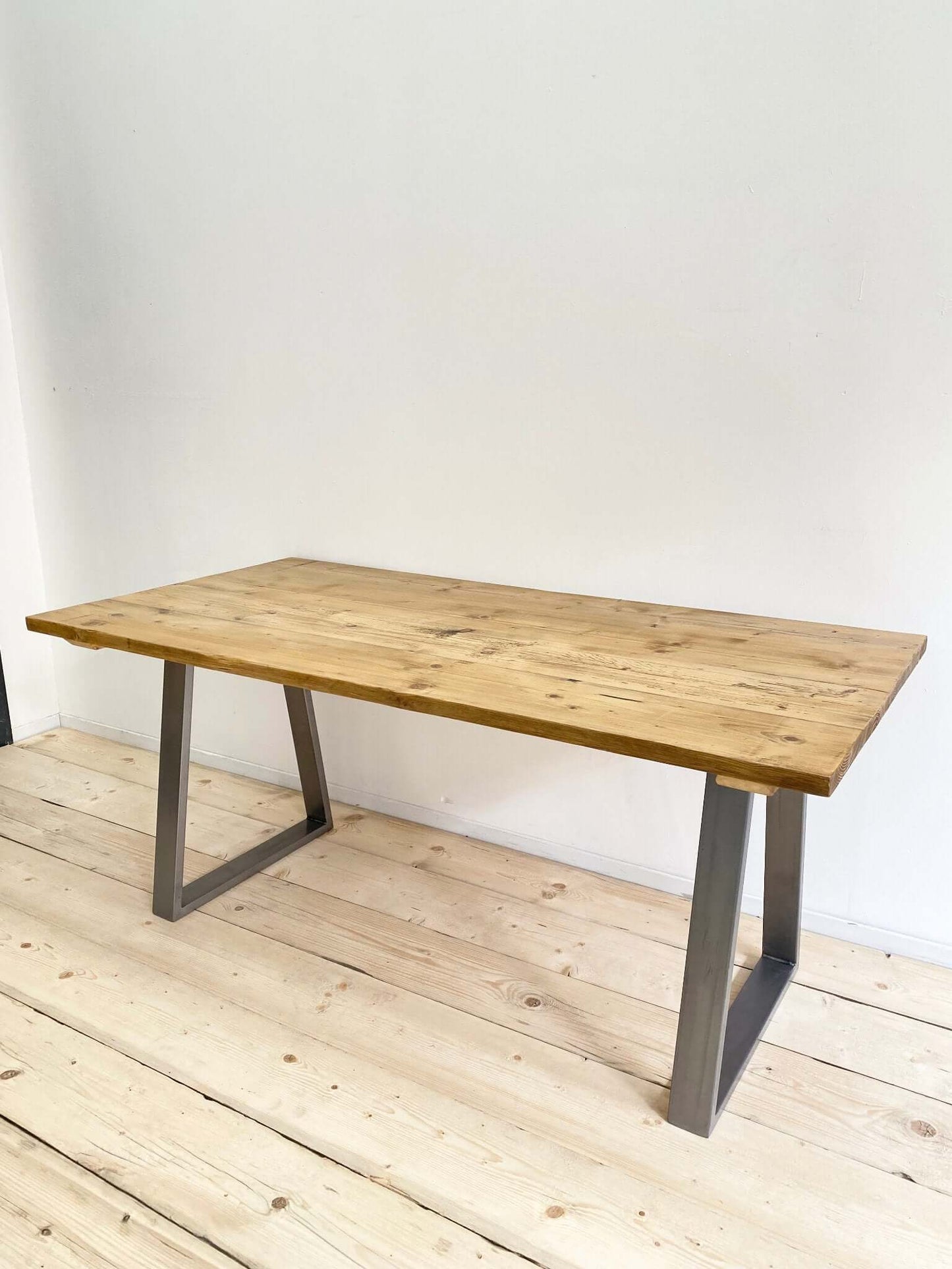 Reclaimed large dining table with industrial legs.