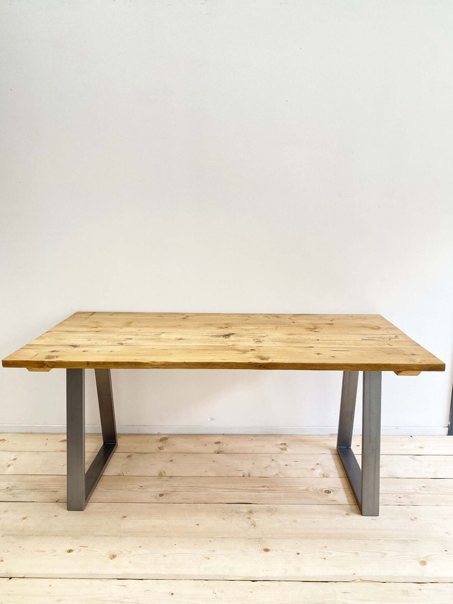 Reclaimed large dining table with industrial legs.