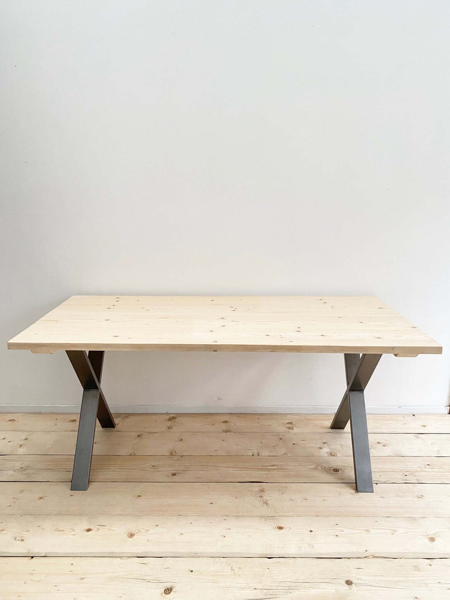 Reclaimed large dining table with industrial legs.