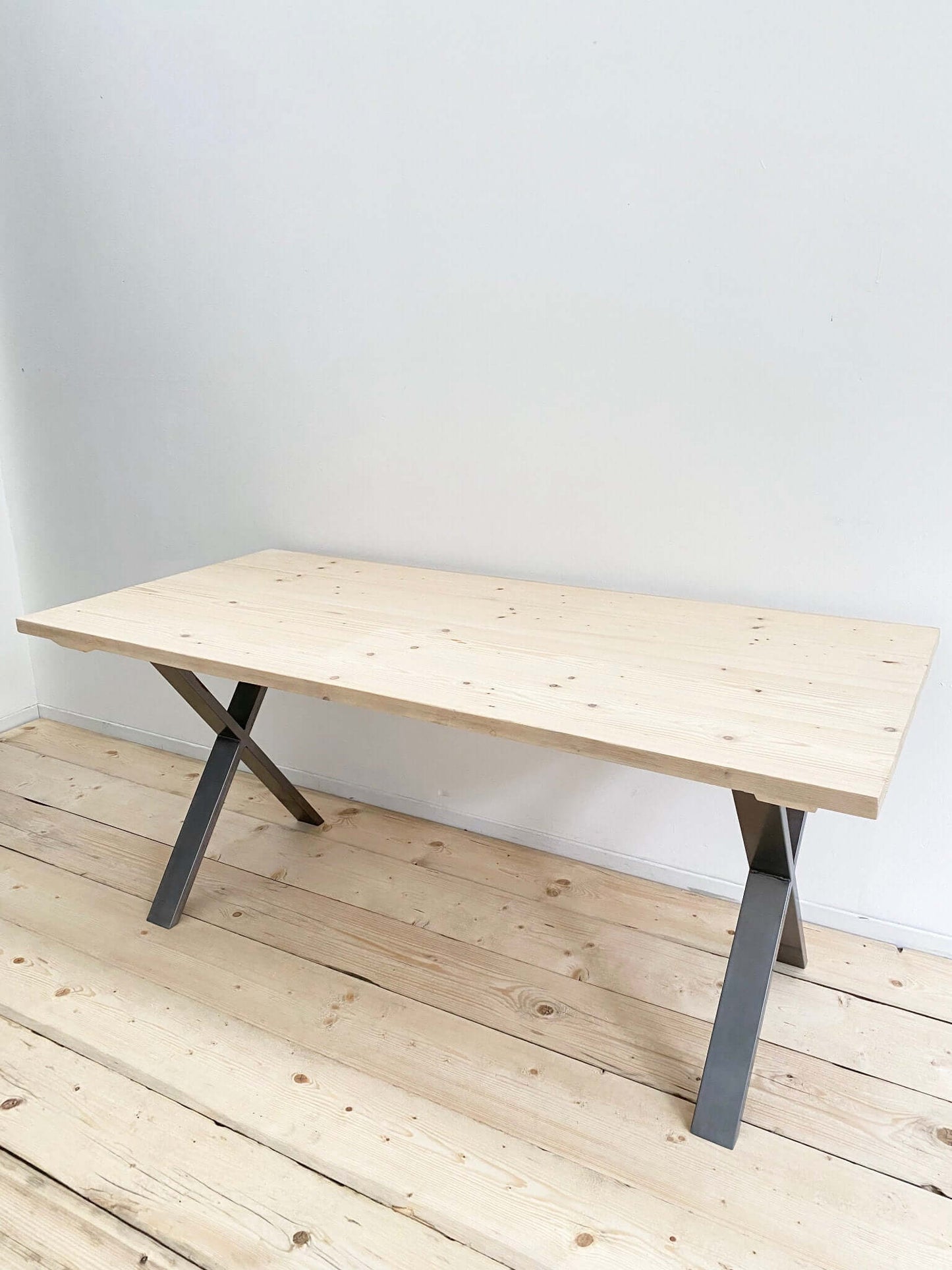 Reclaimed large dining table with industrial legs.