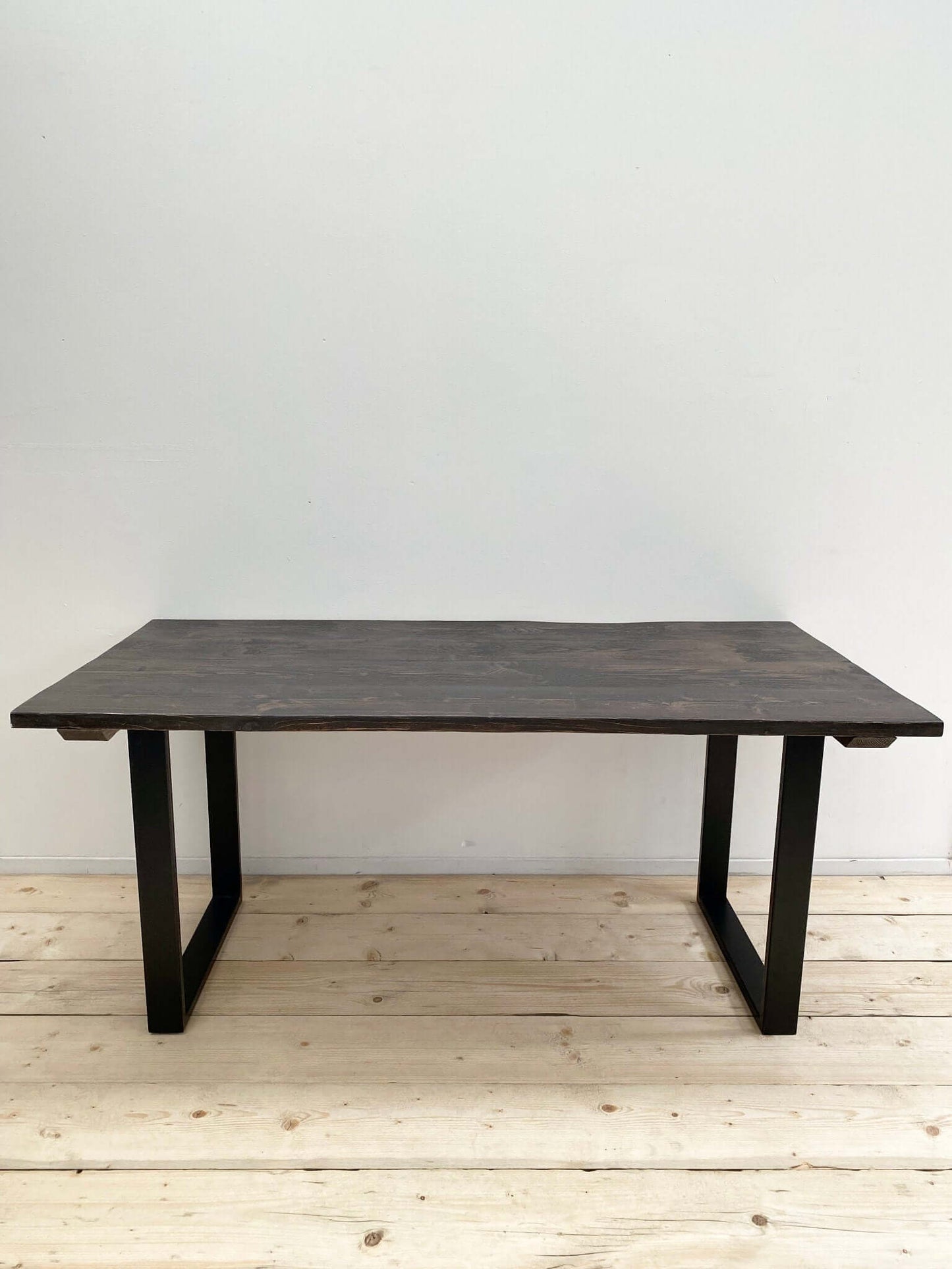 Reclaimed large dining table with industrial legs.
