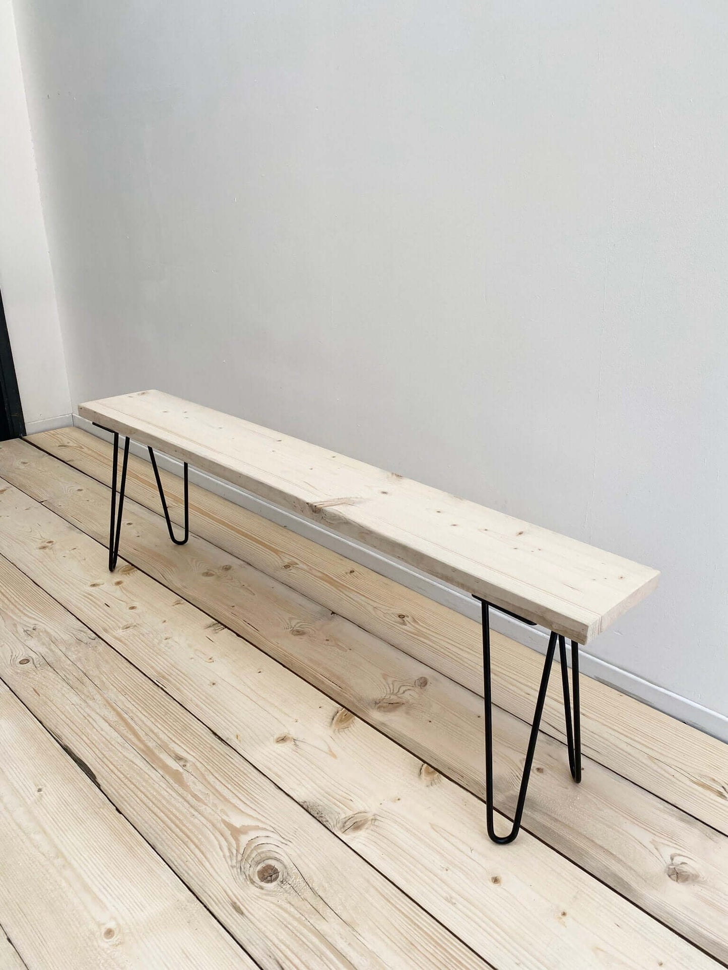 Reclaimed wood outdoor bench with hairpin legs.