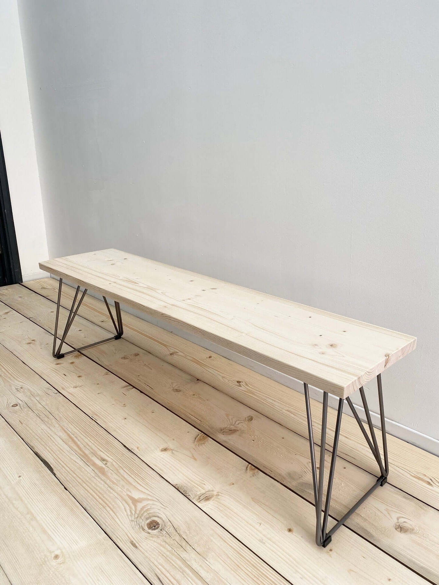 Reclaimed wood outdoor bench with industrial legs.