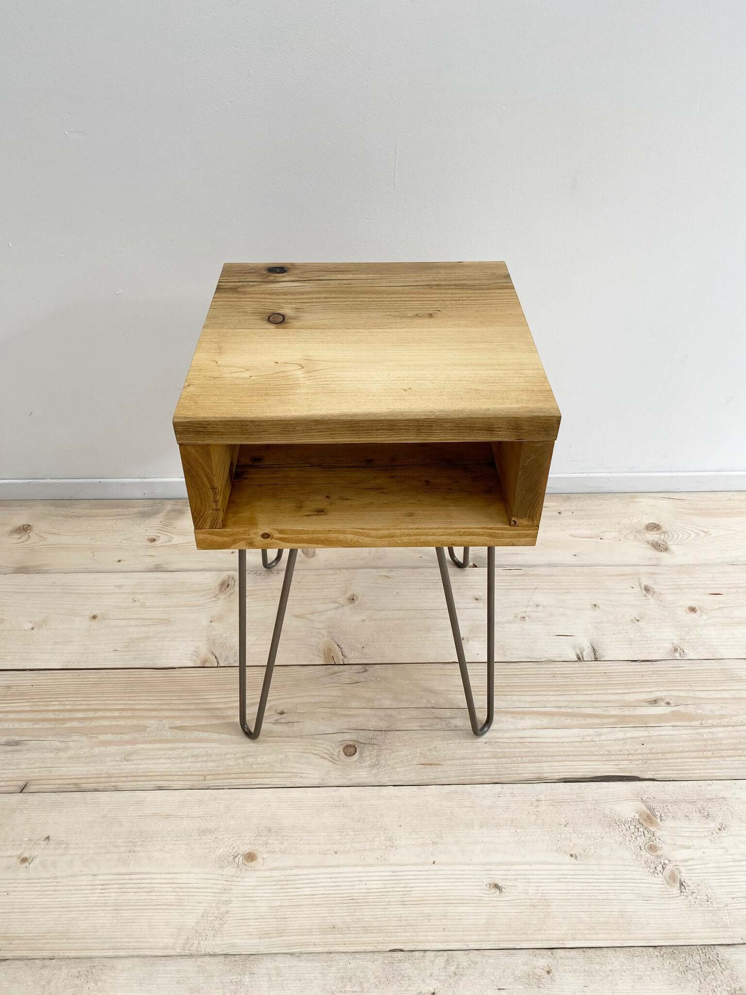 Reclaimed wood side table with hairpin legs.
