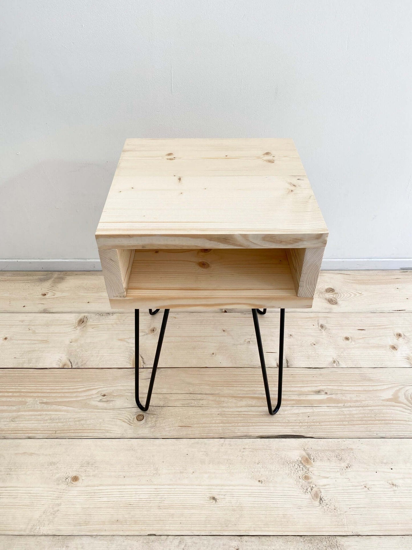 Reclaimed wood side table with hairpin legs.