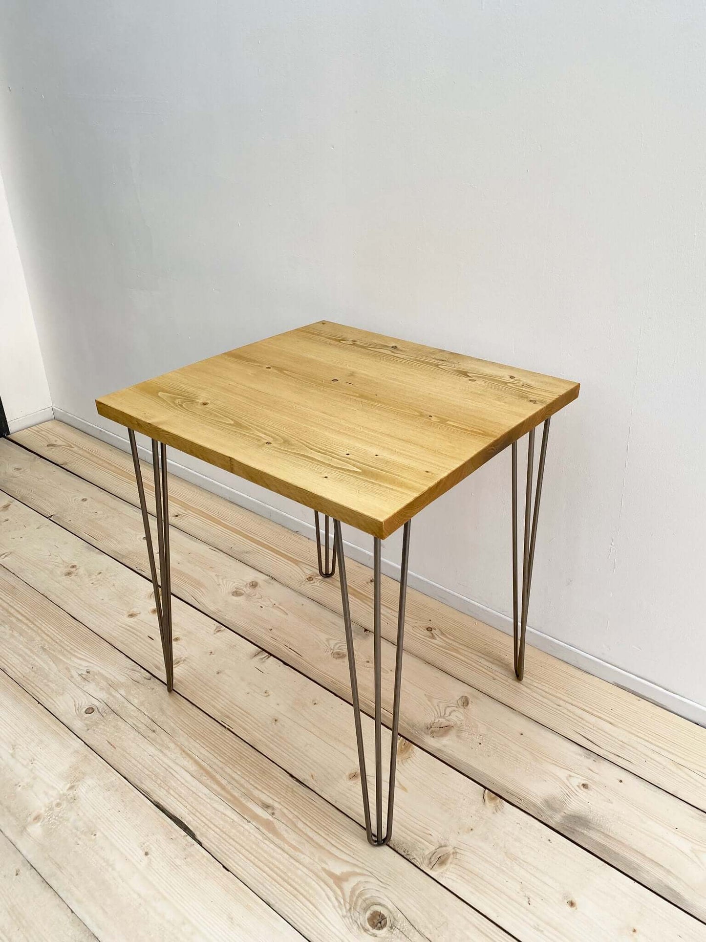 Reclaimed wood small dining table with hairpin legs.